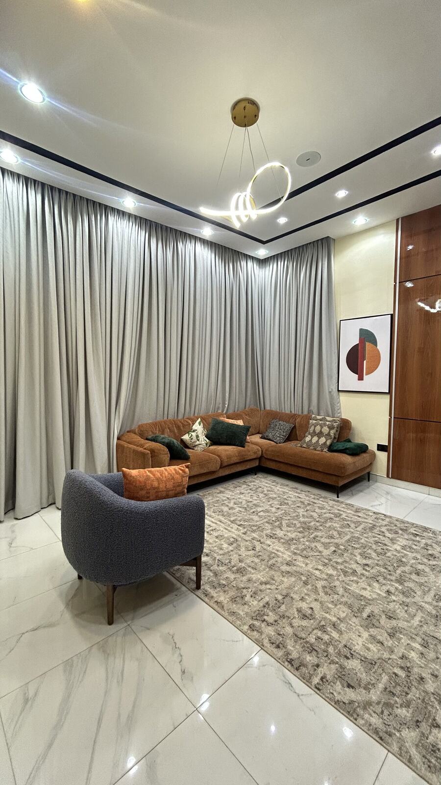 Floor-to-ceiling window curtains in a styled living room